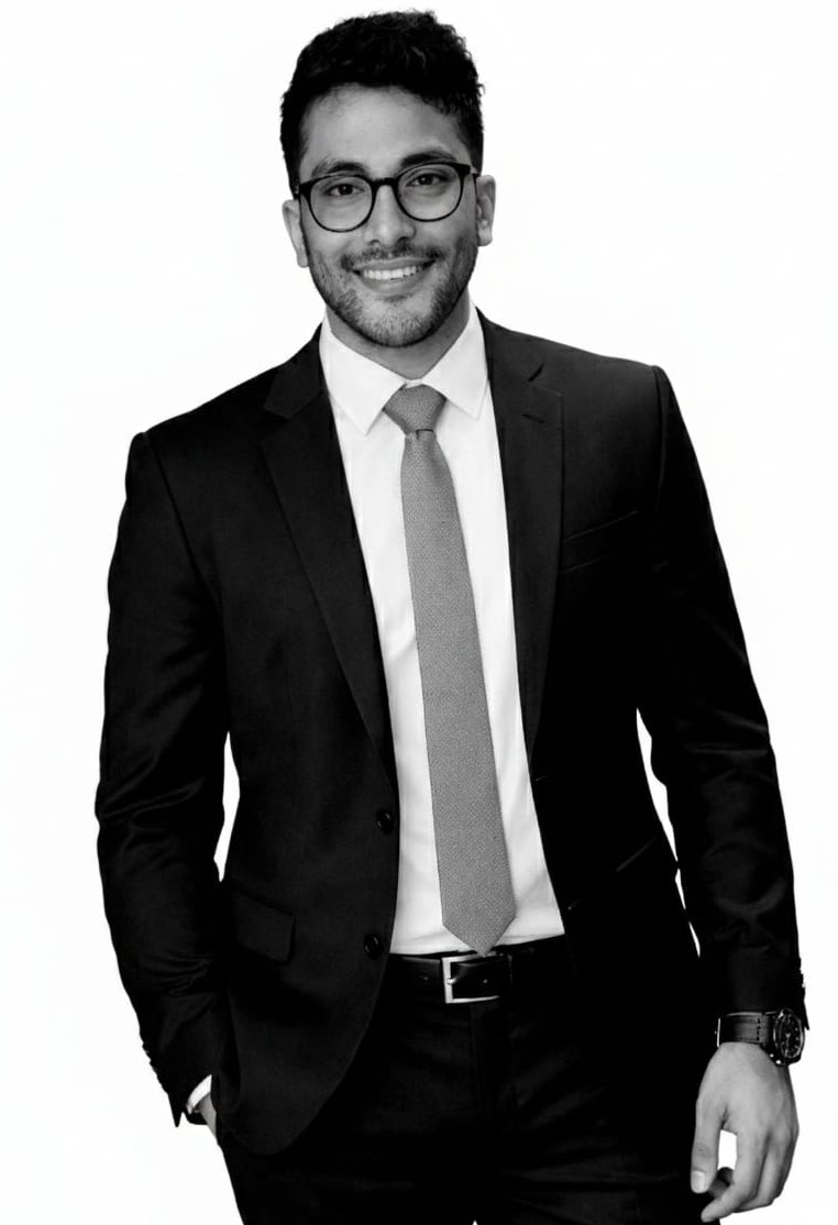 Smiling man in suit and glasses