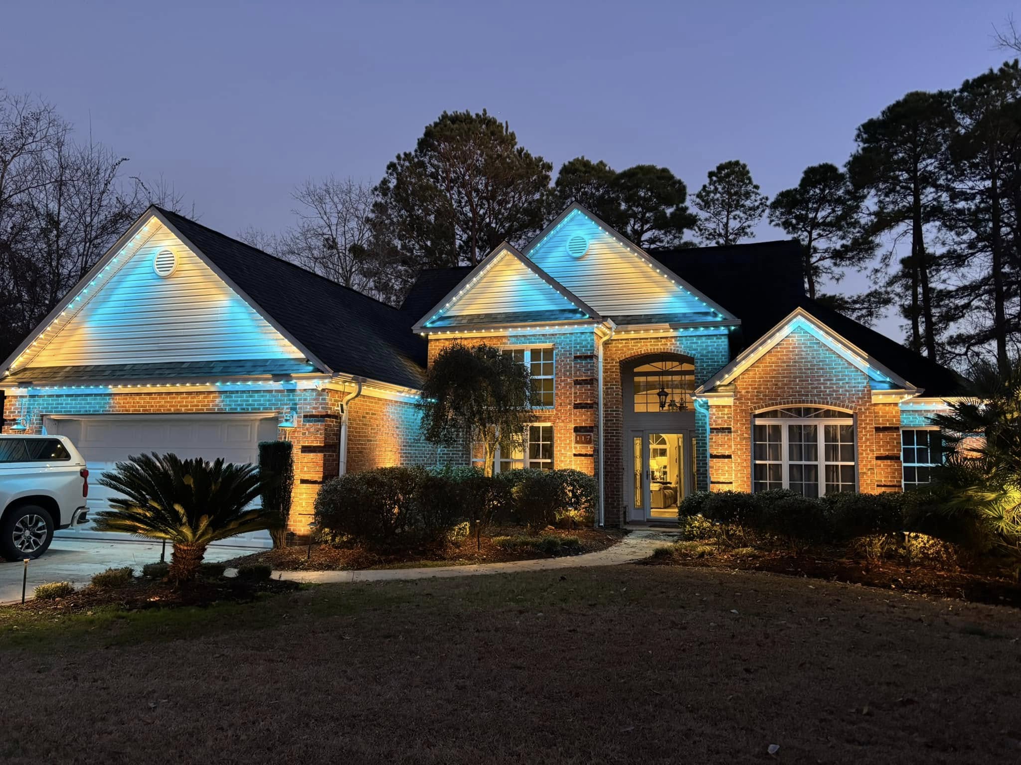 Home with teal permanent lighting at dusk