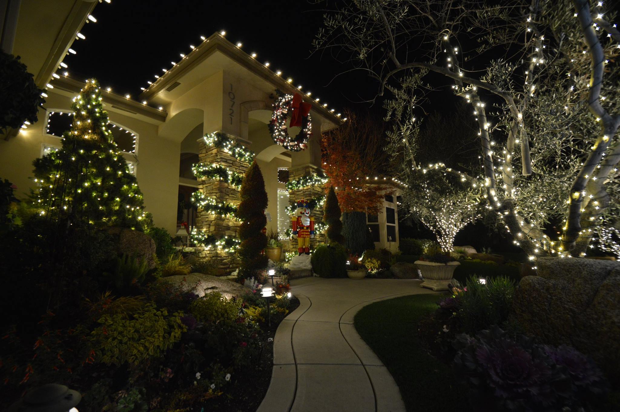 Christmas lights on a Hanford home with wrapped trees