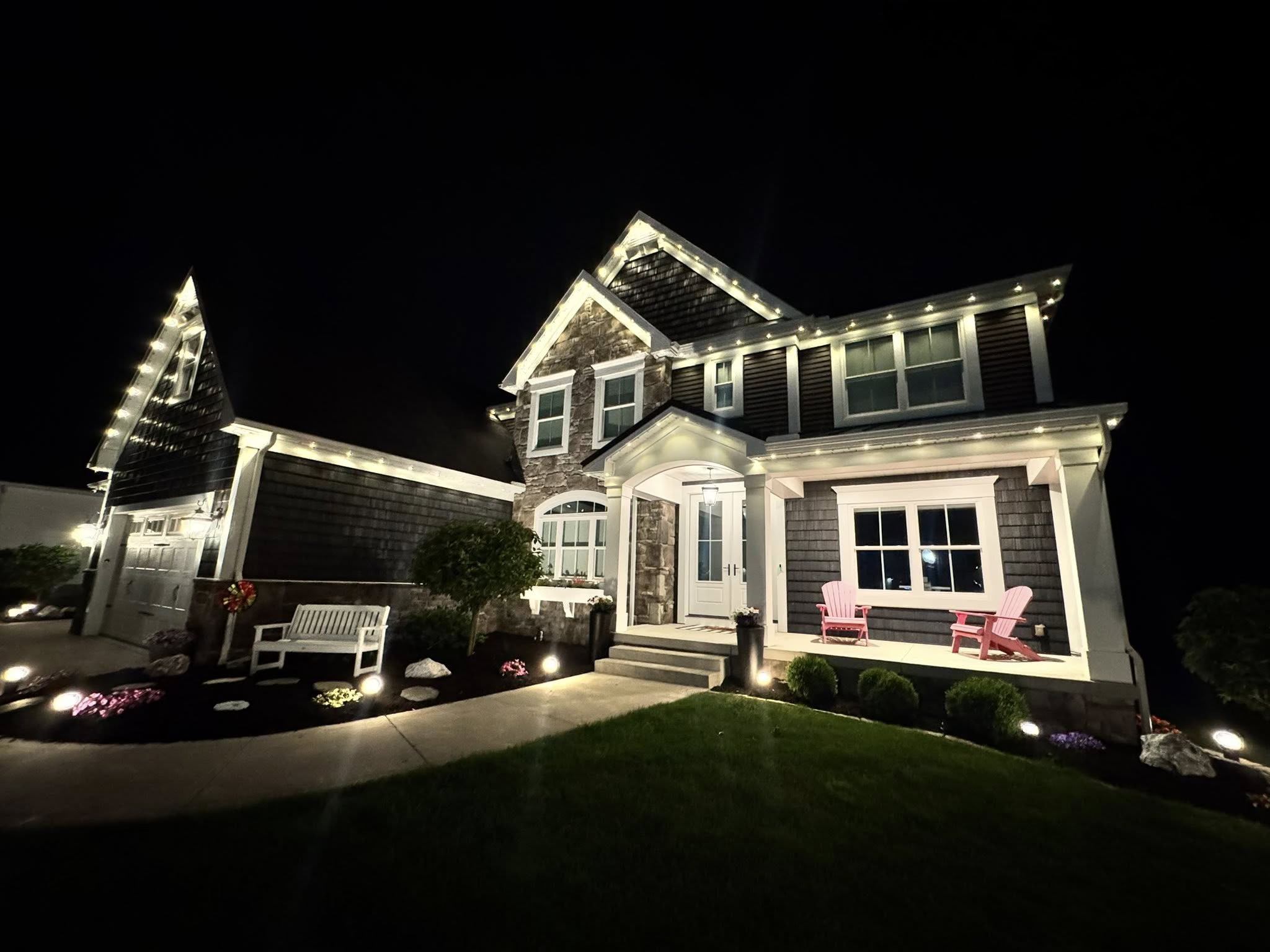 Farmhouse with white permanent roofline lighting
