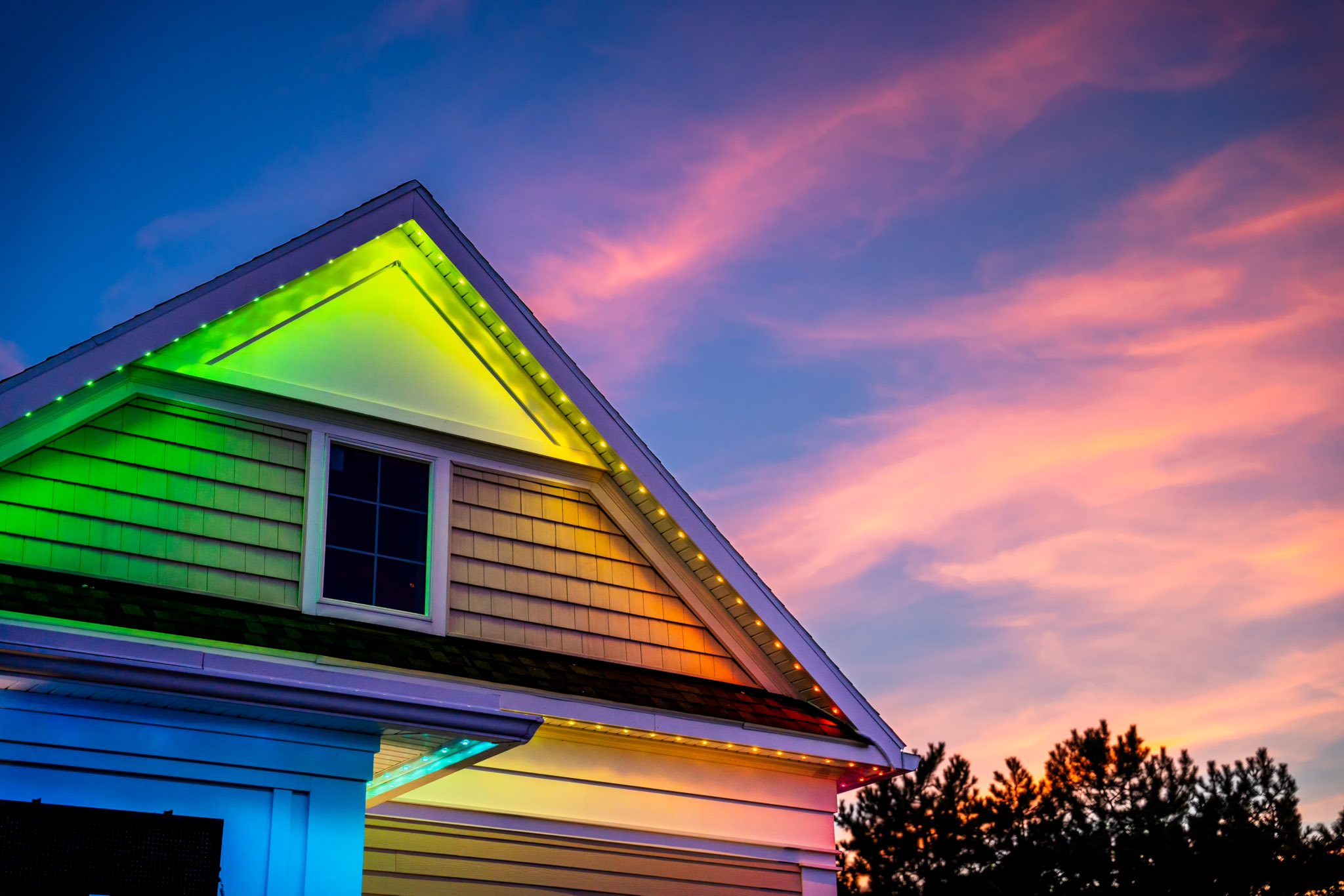 Home with rainbow permanent lighting at sunset