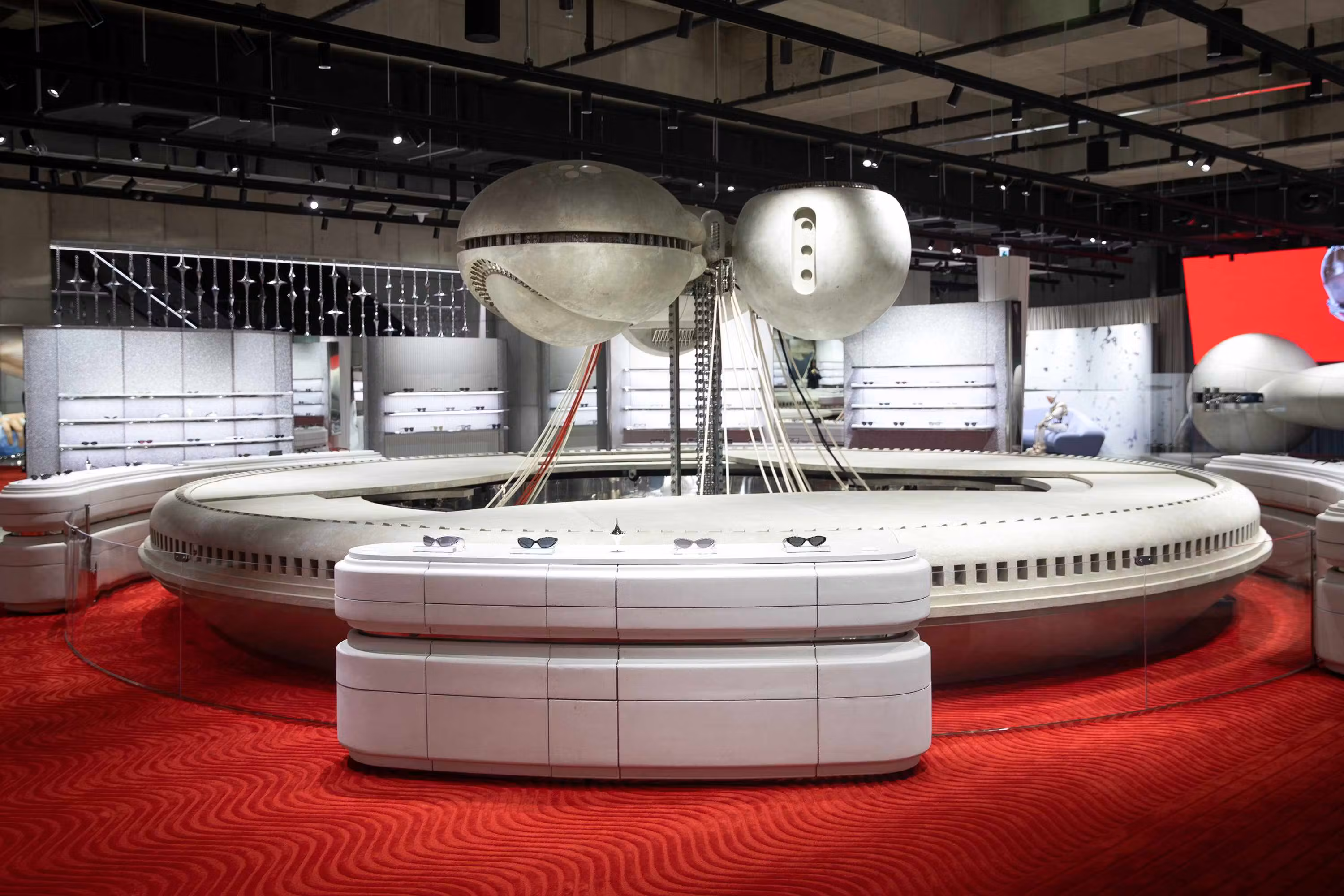 Gentle Monster eyewear displayed inside Haus Nowhere Seoul with robotic sculptures and futuristic lighting.