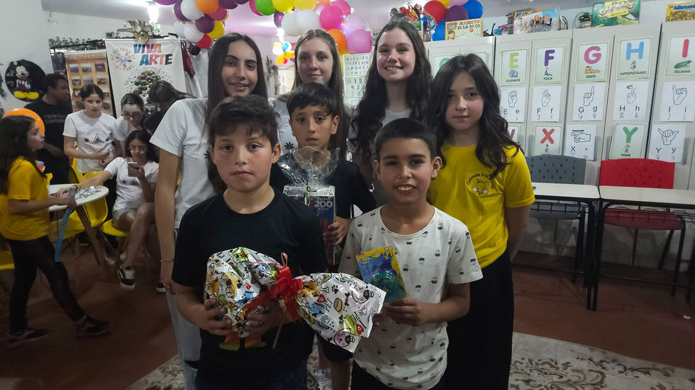 Alunos recebendo os presentes doados pelas voluntárias