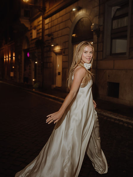 Monica in a white dress running