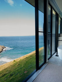 A bathroom looking out to the coast