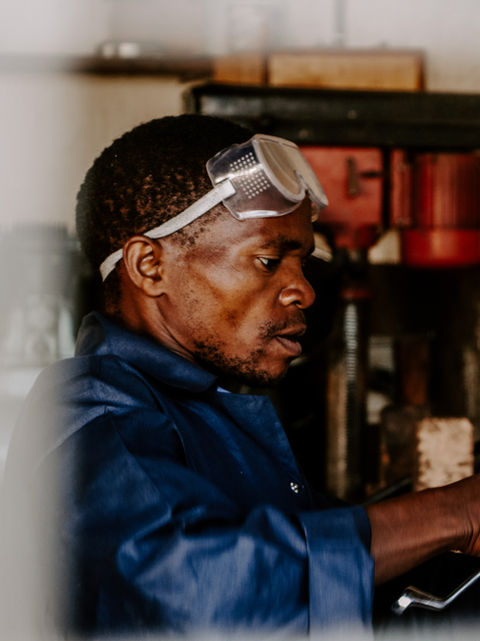 A man working at the workshop of utengule coffee farm. 