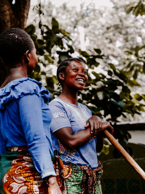 Women working on the Utengule Coffee Farm, in their colourful dresses and a big smile on their face. 