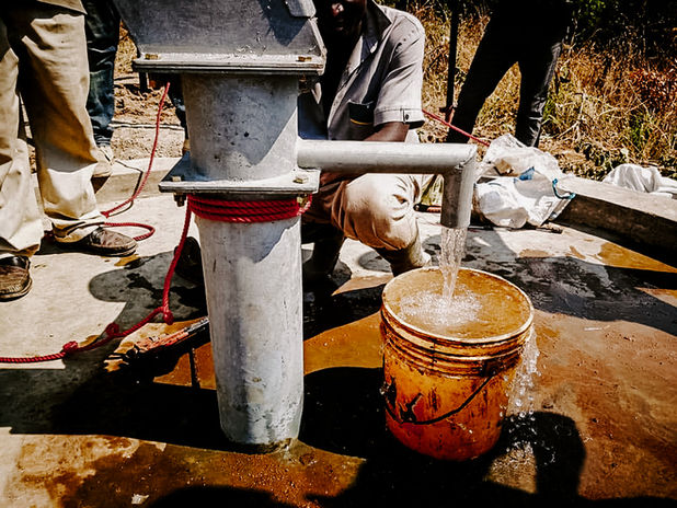 fresh drinking water coming out of newly built bore hole , community work of Utengule Coffee 