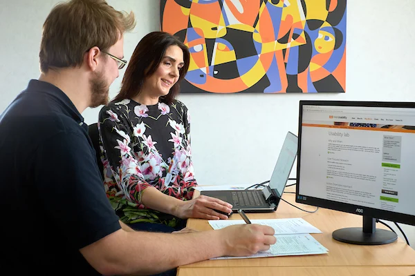 A man and woman performing a usability test
