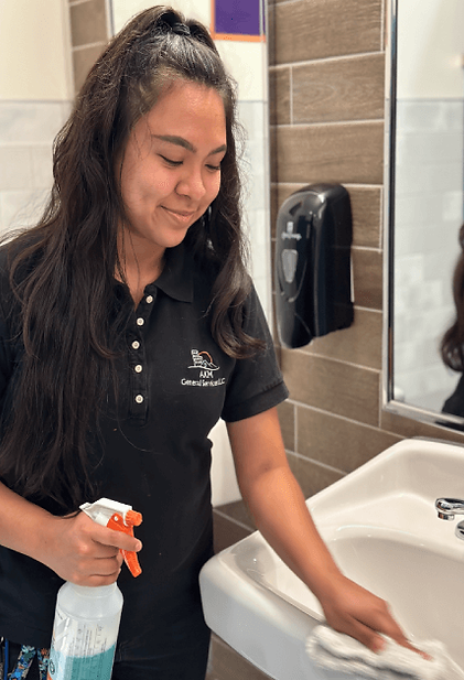 Woman Cleaning School Bathroom Sink (1).png