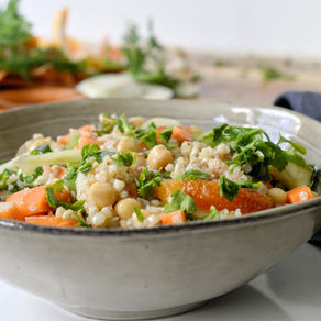 Buckwheat salad with chickpeas, fennel, carrots, and orange segments in a bowl