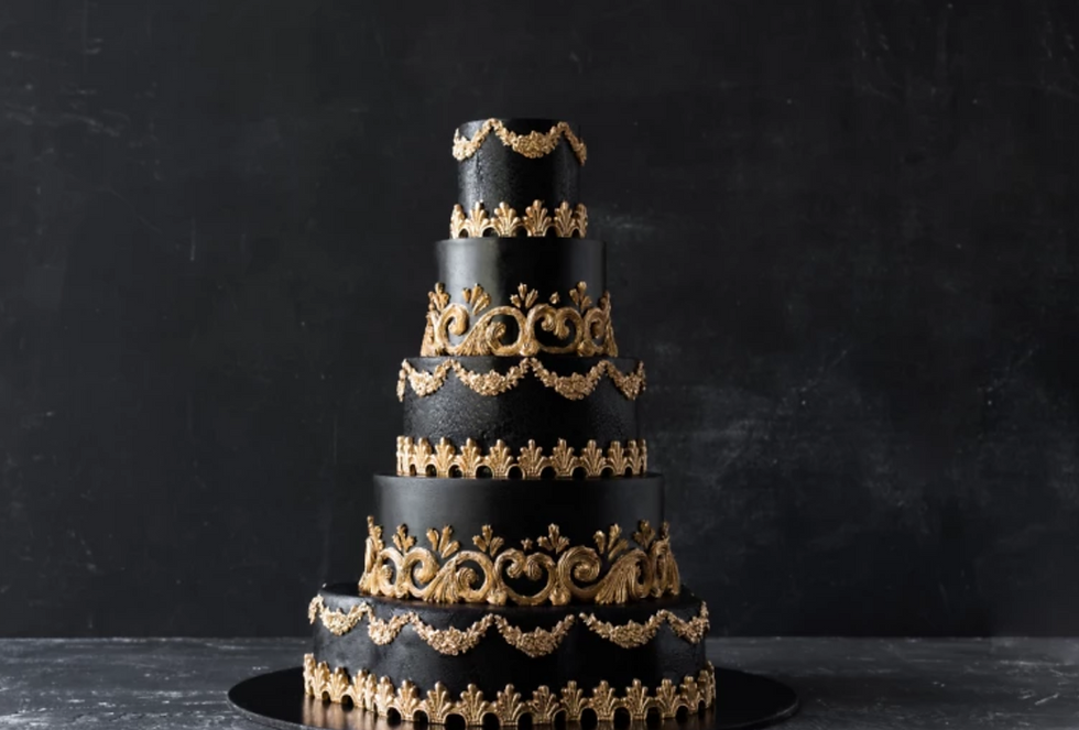 Elegant five-tier black cake with intricate gold decorations, set against a dark background, creating a luxurious, sophisticated mood.