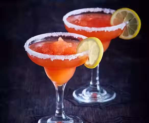 Orange coctail drinks with lemon on the rim
