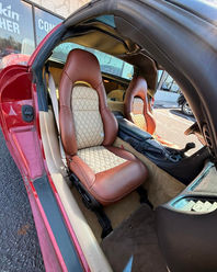 Custom brown and tan diamond-stitched leather seats in a red convertible Corvette
