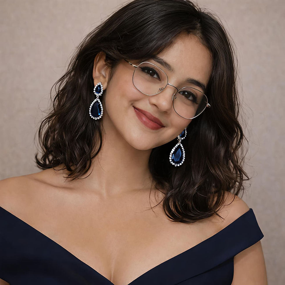 Smiling woman wearing glasses and blue earrings