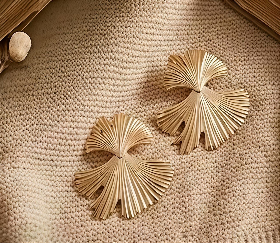 Two gold fan earrings on beige knit