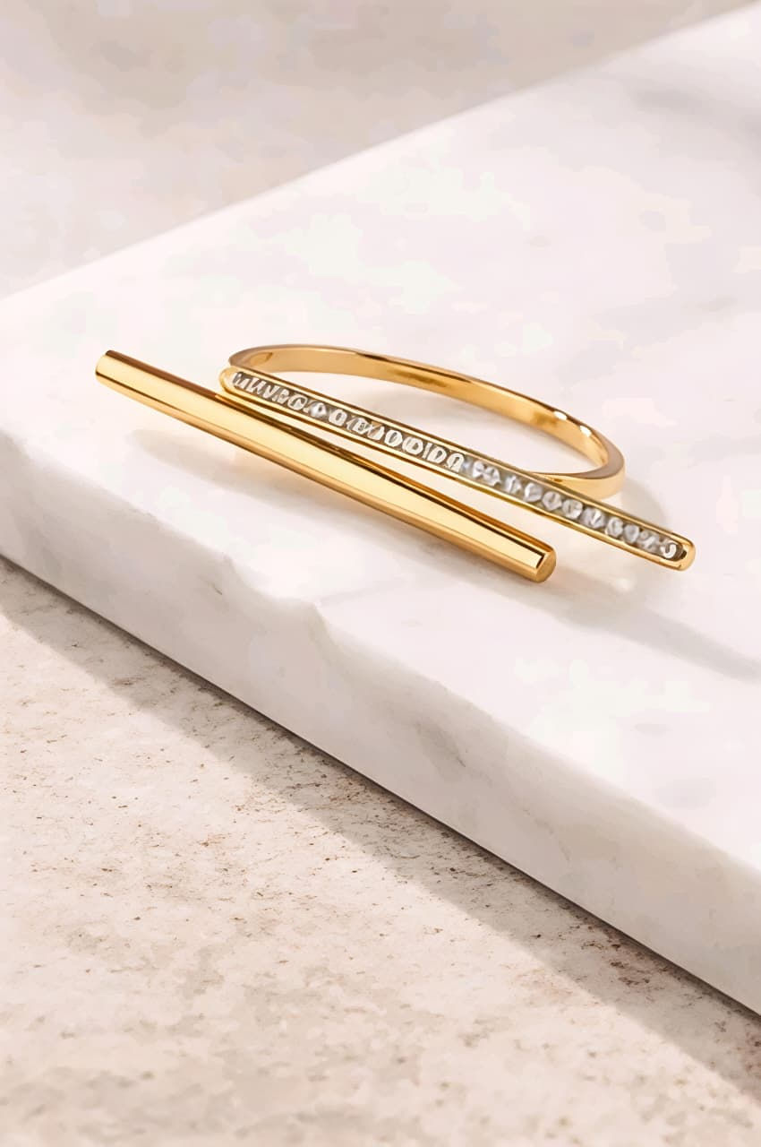 Gold cuff bracelet with gem-studded bar