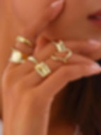Hand with various gold rings