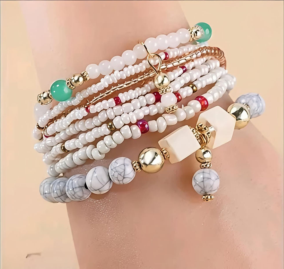 Stacked bracelets with white, marbled gray, gold, and green beads