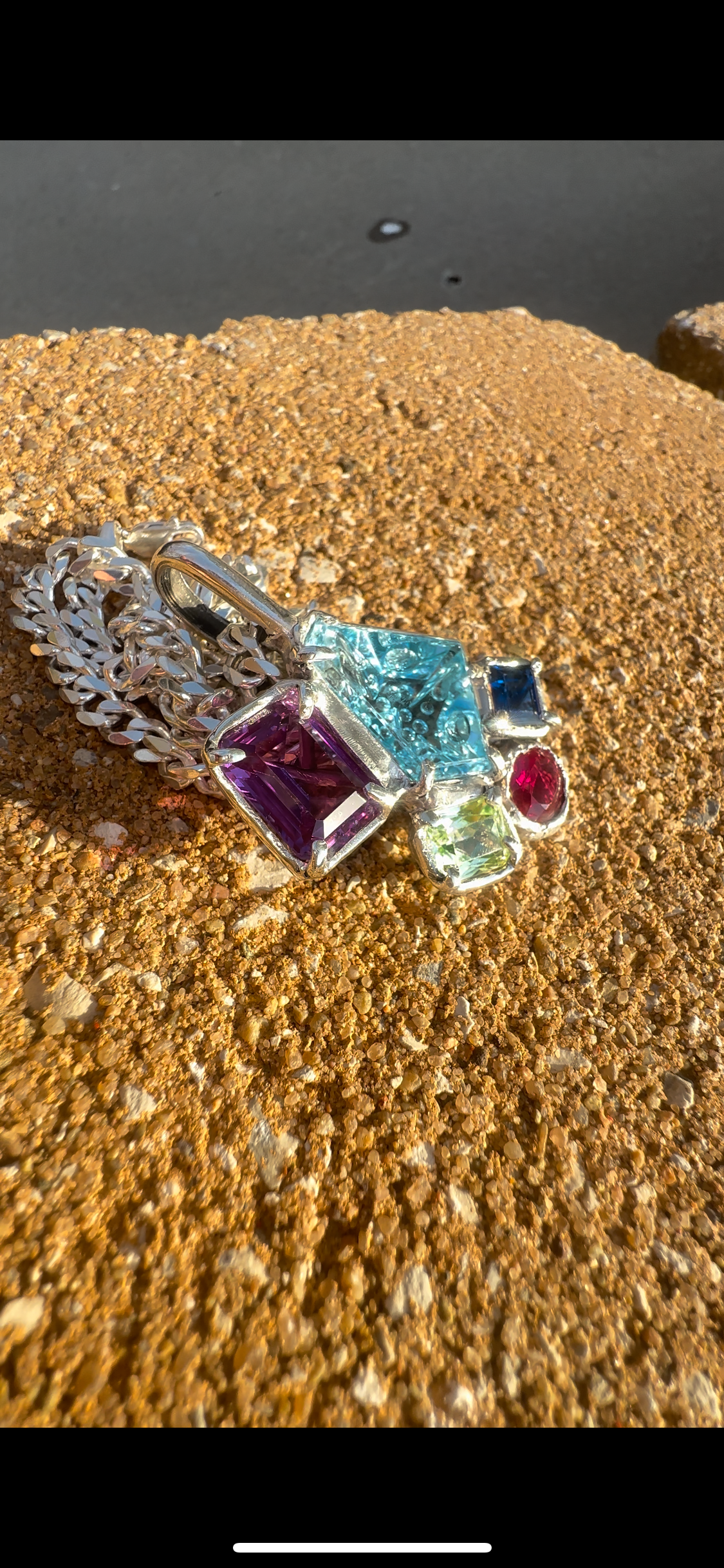 One of a kind hand made pendant containing hand cut illusion cut blue topaz 