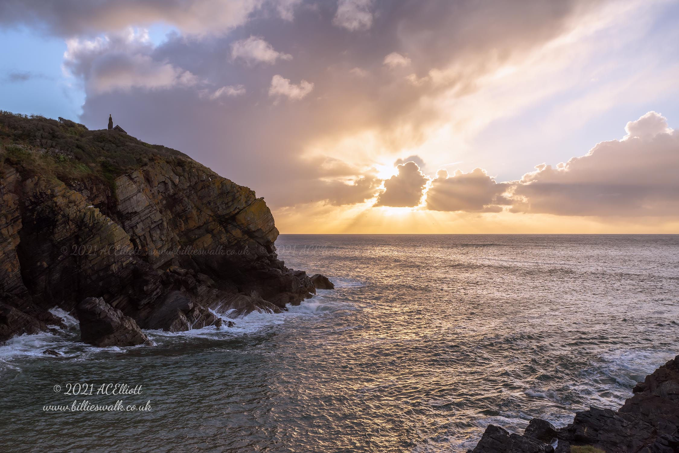 Sunrise, and rays from behind clouds in Cadgwith Cove photo and fine art print