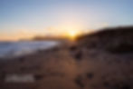 Sunburst over the headland beyond Kennack Sands photo