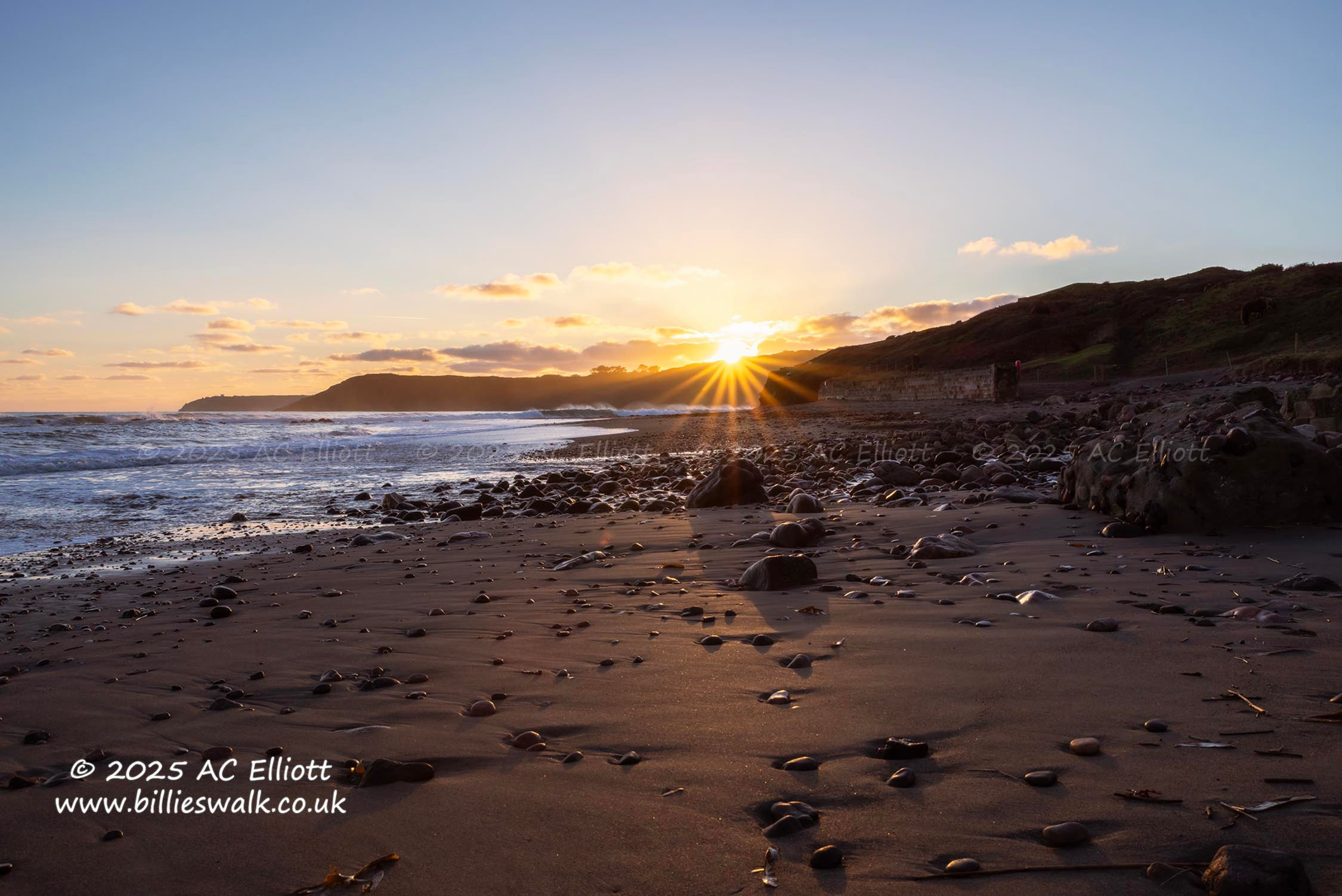 Sunburst over the headland beyond Kennack Sands photo