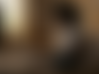 A young leading sitting in bed and typing on laptop