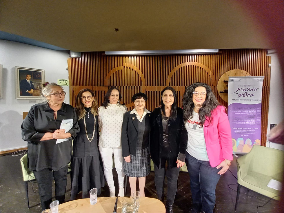 A group of women stands and smiles at the camera