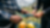 Close-up view of hands tying a rope knot during an outdoor team task