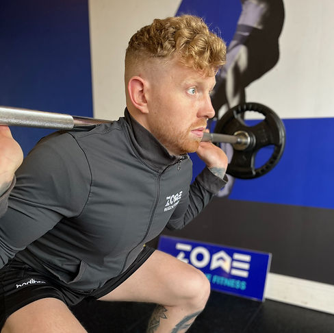 Coach demonstrating deadlift