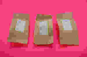 This is a photo of Dr. Yang Wellness tea in it's individual packaging on a pink background.
