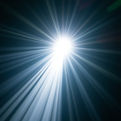 Bright silver light burst with beams, illuminated in a dark background.