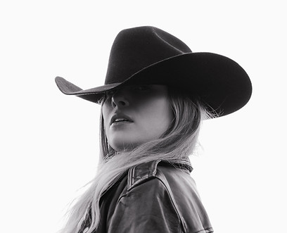 Black and white portrait of Savannah Dodge in wide-brimmed hat – artistic interior design inspiration