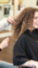 laughing women curly hair stylist salon