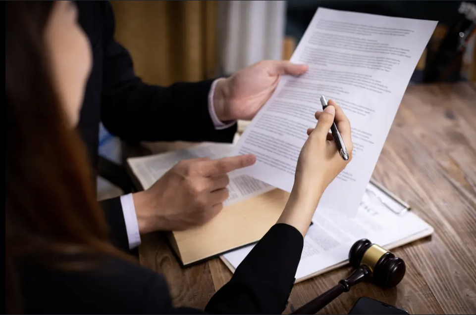 Business consultant reviewing a government contract proposal to ensure compliance and submission readiness.