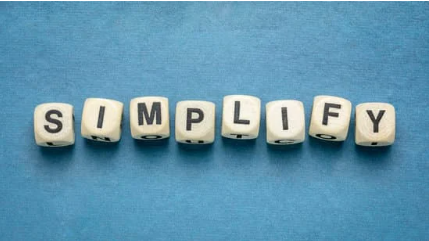 Letter blocks spelling "SIMPLIFY" arranged on a blue background.