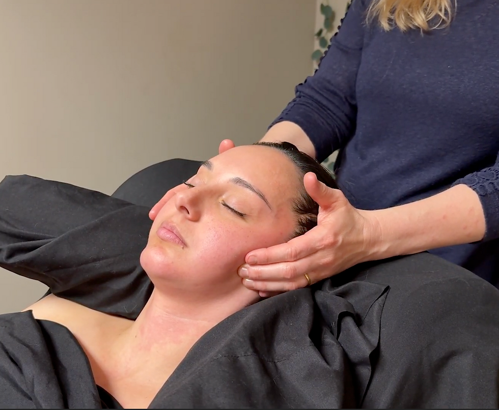Therapist performing facial massage on a client to promote deep relaxation and stress relief, part of therapeutic massage in Highlands Ranch.