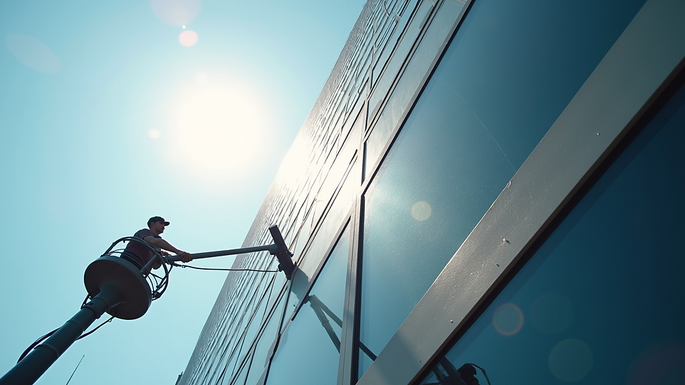 Eye-level view of a high-rise building exterior being cleaned