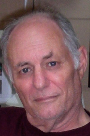 Man with grey hair looking forward