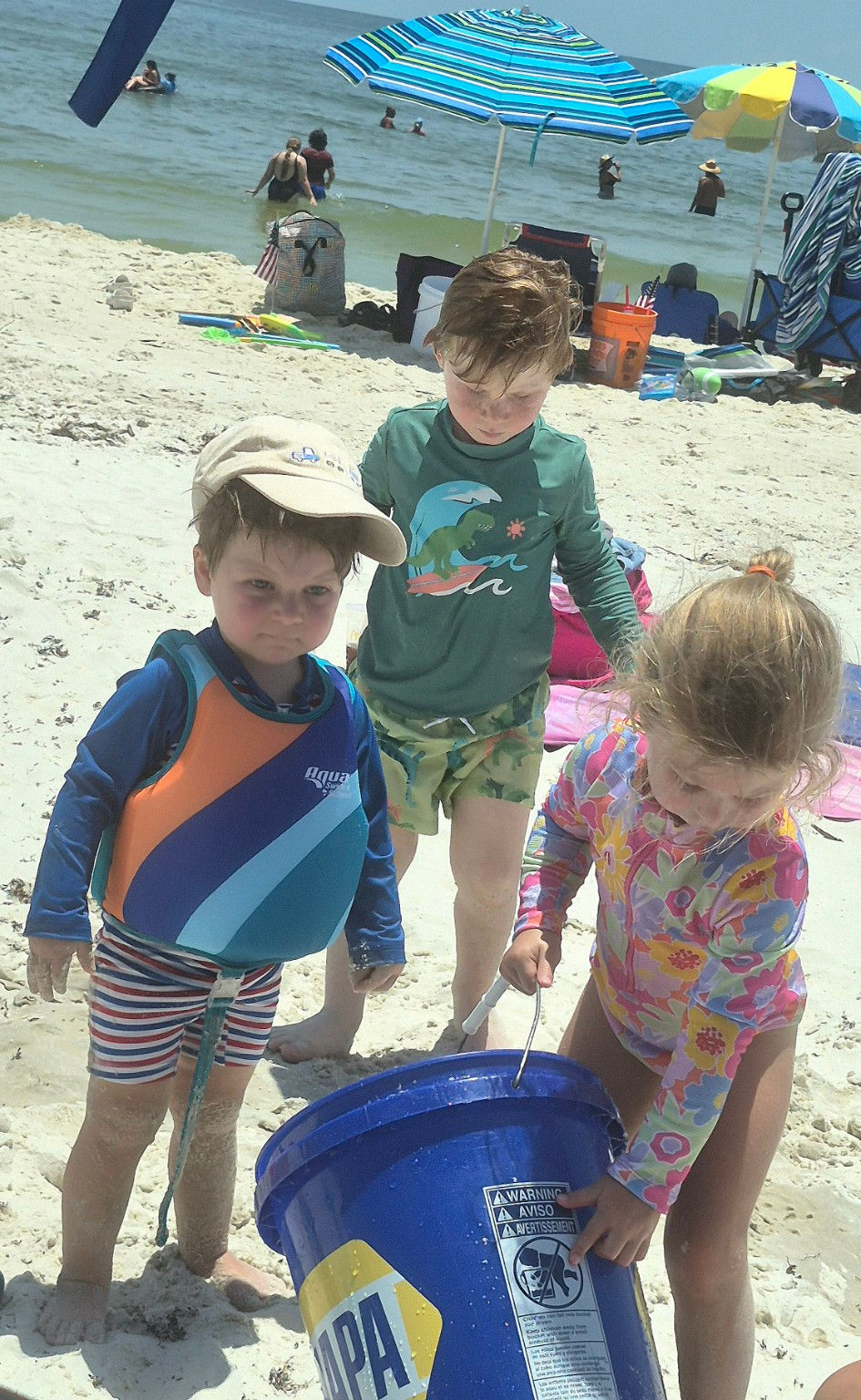 Wallace, Rhys and Ann Evelyn, play together on the beach at Gulf State Park in June.