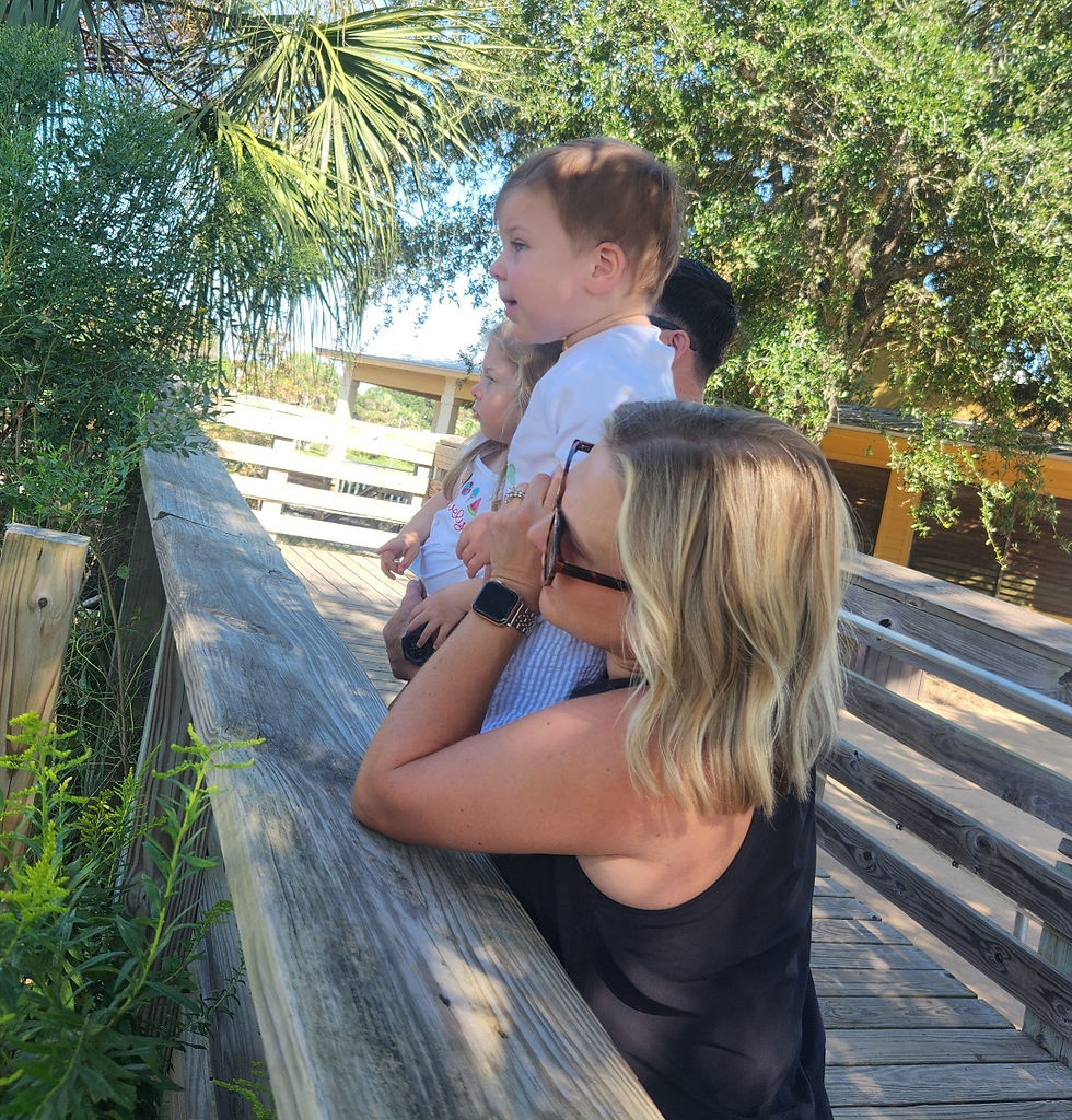 Wallace and Ann Evelyn admire the giraffes with their parents recently at the Alabama Gulf Coast Zoo. (Wayne Smith photo)