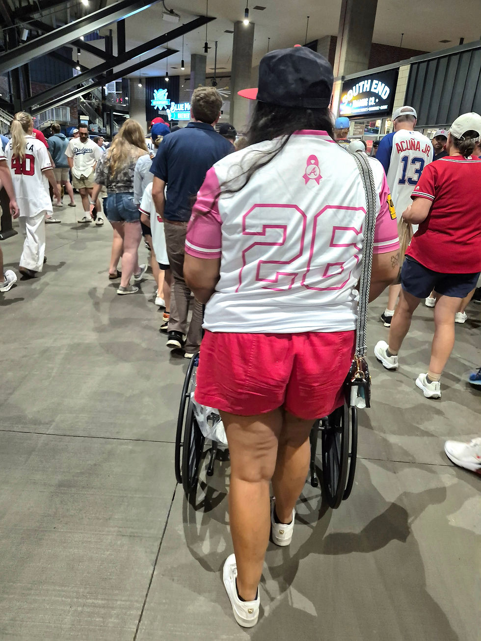 Kerri pushes her friend through the concourse at Truist Park following the Braves’ win over the Blue Jays.