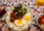 A Plate with sunny side up eggs, home fries, and greens