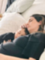 exhausted mom resting with her toddler son