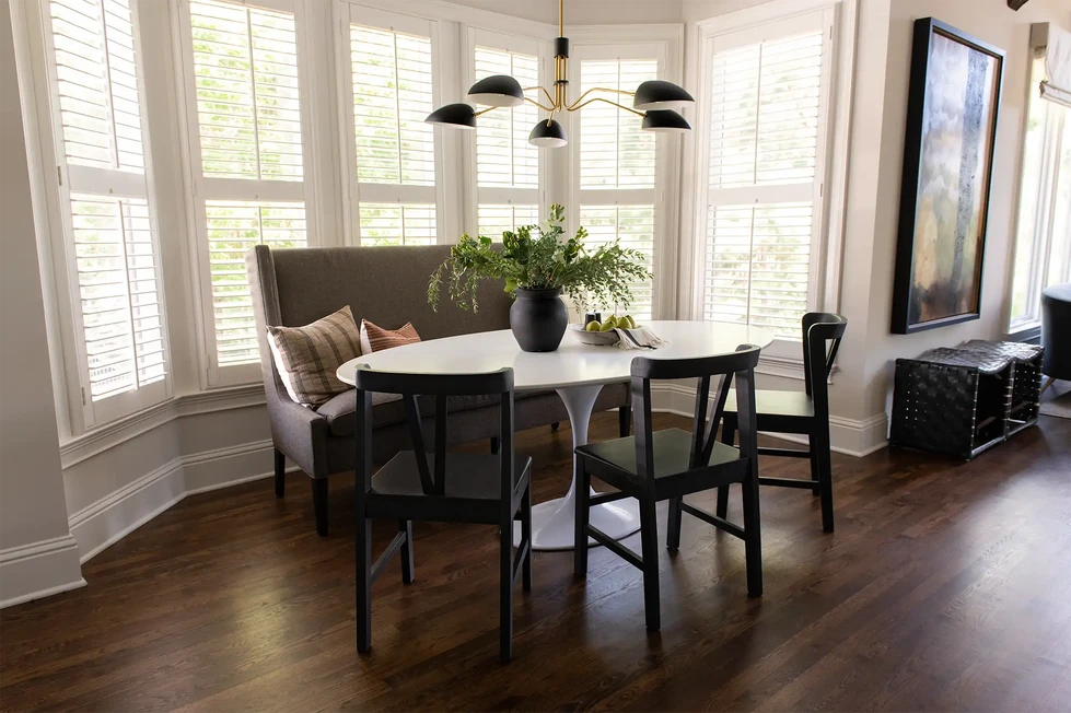 kitchen table | dining room | dining room table | upholstered bench seat | table and chairs | modern chandelier | bow window | bay window