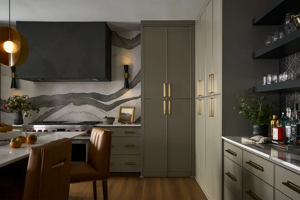 Kitchen cabinetry with concealed hidden pantry door flush with cabinets and brass hardware