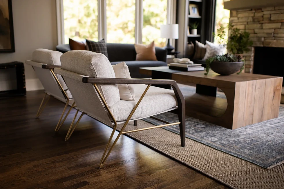 keeping room | stacked stone fireplace | modern wood arm chairs | modern wood coffee table | blue sofa | blue couch | blue area rug