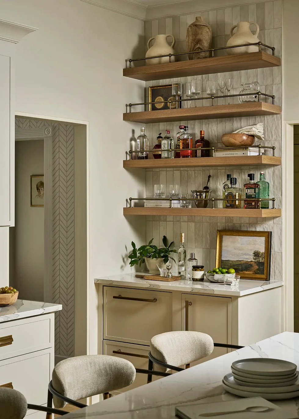 Home bar | floating wood shelves | brass railing | tile backsplash | icemaker | refrigerator drawers