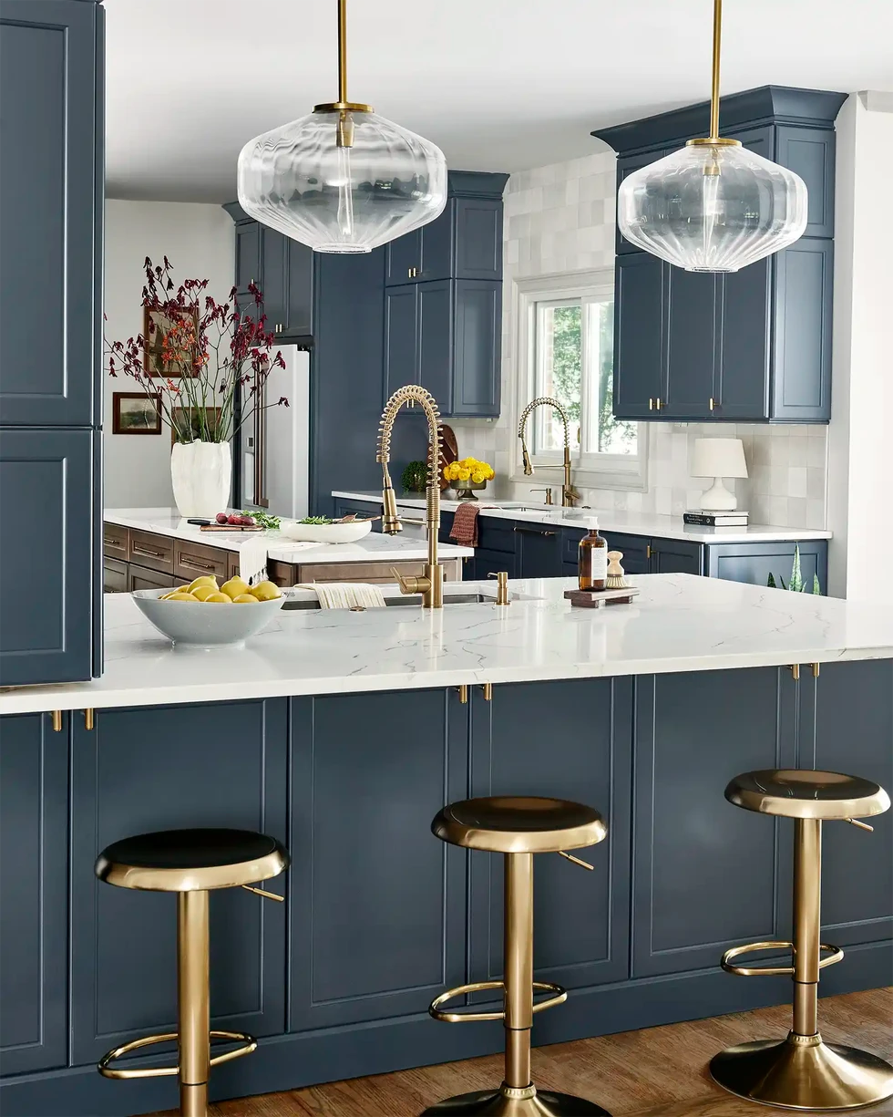 Kosher kitchen renovation | dark blue kitchen cabinets | brass barstools | kitchen island | kitchen glass pendant lights